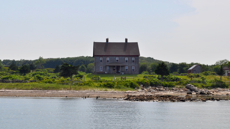 A cottage stands above a beach on Naushon Island, Massachusetts