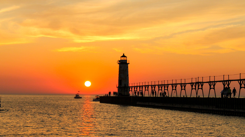A pier and lighthouse at sunset in South Haven, Michigan.