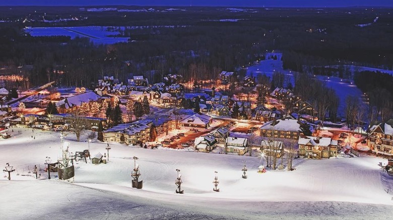 Night shot of Crystal Mountain Resort with lights on at bottom of slopes