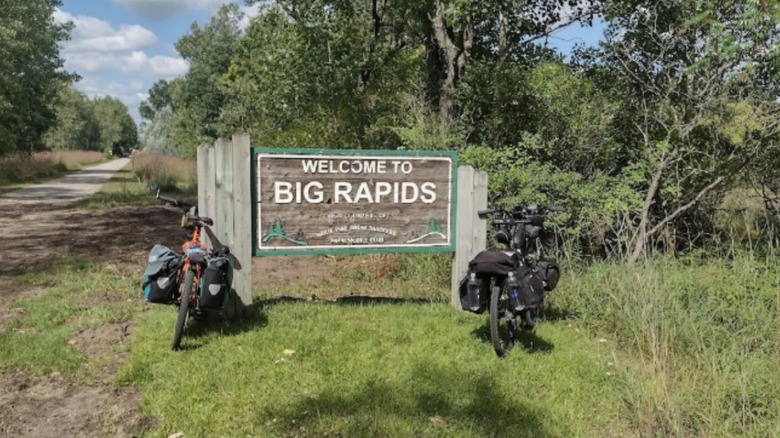 A sign for Big Rapids with bikes next to it on Fred Meijer White Pine Trail.