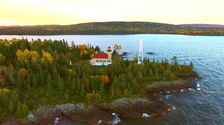 Copper Harbor lighthouse on a rocky outcropping in a Lake Superior bay