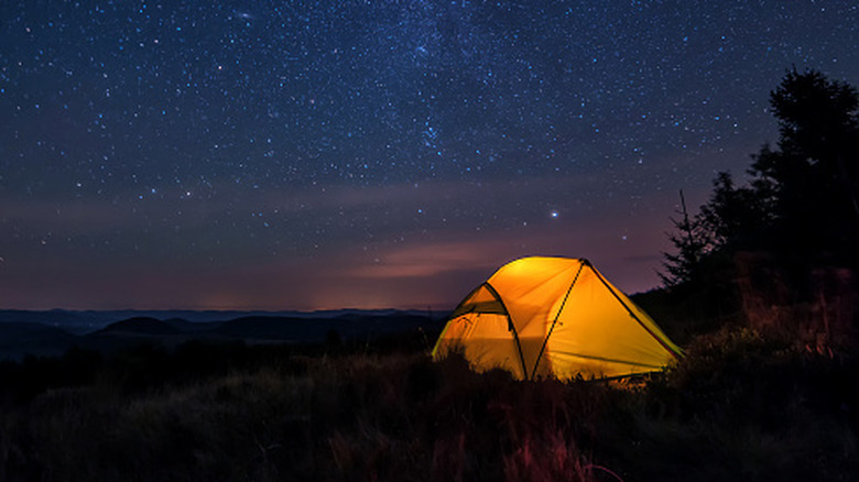 camping under a star filled dark sky