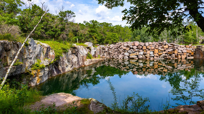 Pond surrounded by colorful bluffs and lush forest in Minnesota's Quarry Park & Nature Preserve, Minnesota