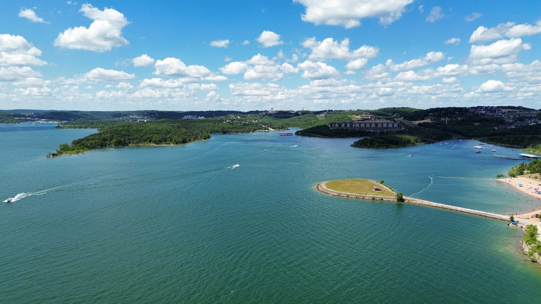 blue-green Table Rock Lake with peninsulas, sandy beach, and boats