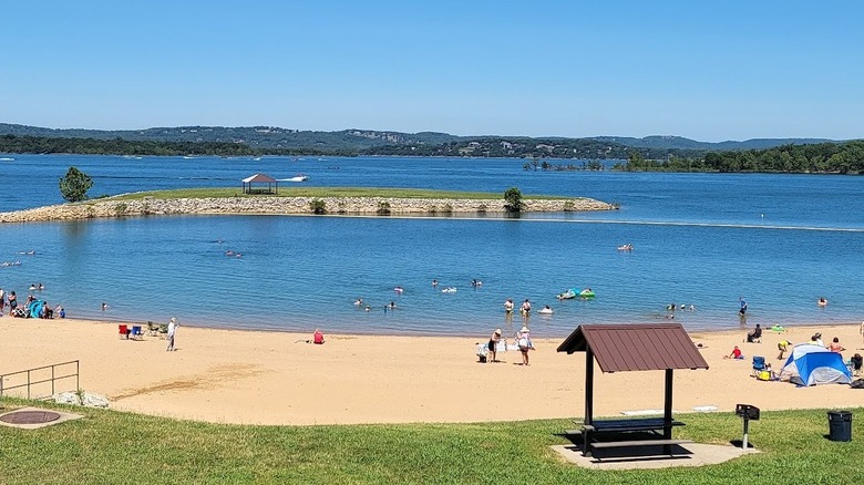 beachgoers on sandy beach and in the swimming area at Table Rock Lake
