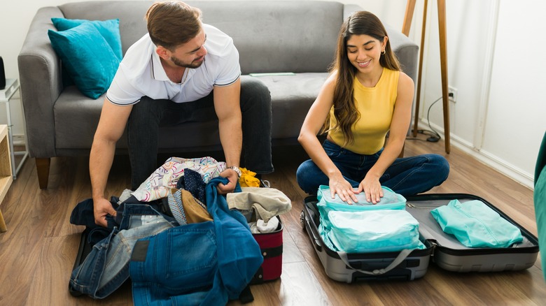 couple packing suitcases