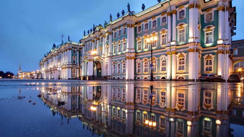 Winter Palace and Hermitage Museum at night, reflected in a wet street in front