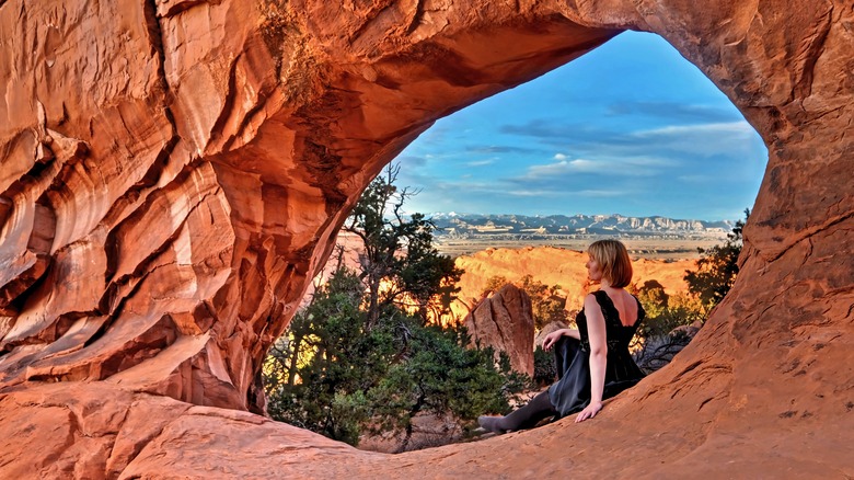 Girl sitting in natural arch