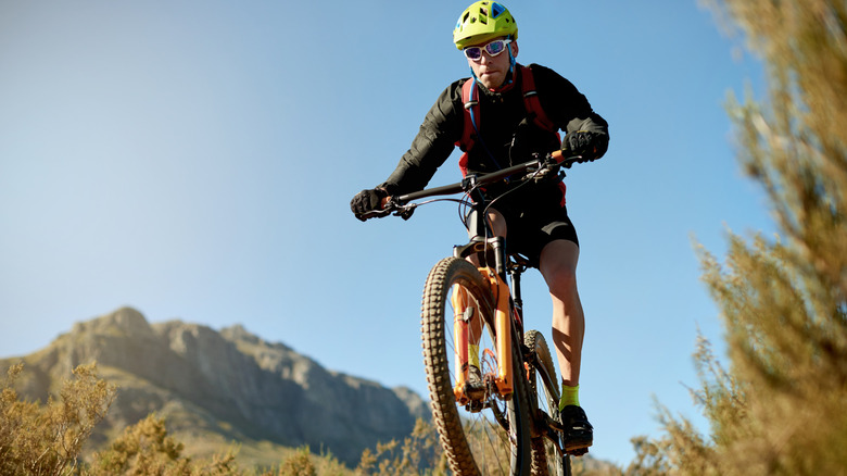 A man on a mountain bike coming down a mountain trail