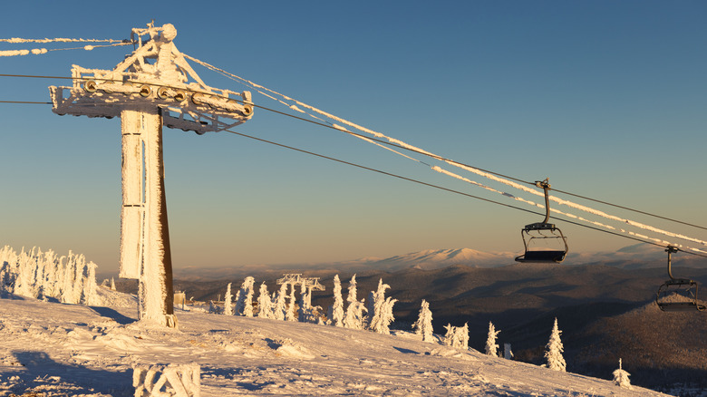An abandoned ski lift covered in snow up in the mountains