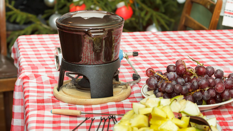 Pot of chocolate fondue with dippers