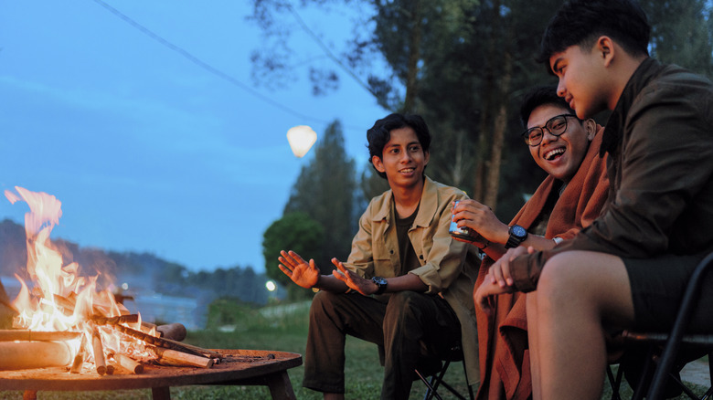 Friends gathered around the campfire