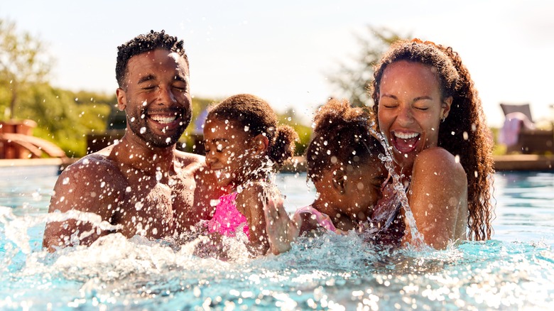 family of four playing happily