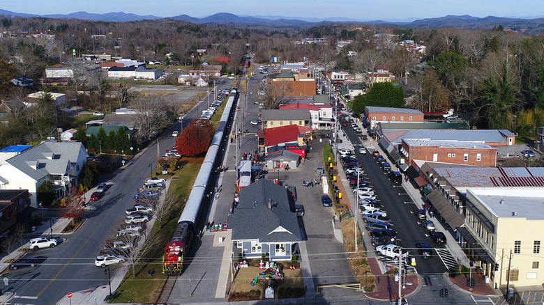 a train pulling into the station in downtown Blue Ridge with the Blue Ridge Mountains in the background in North Georgia