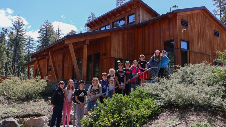 a group of children on a NatureBridge program standing on the steps of the National Environmental Science Center in Yosemite National Park