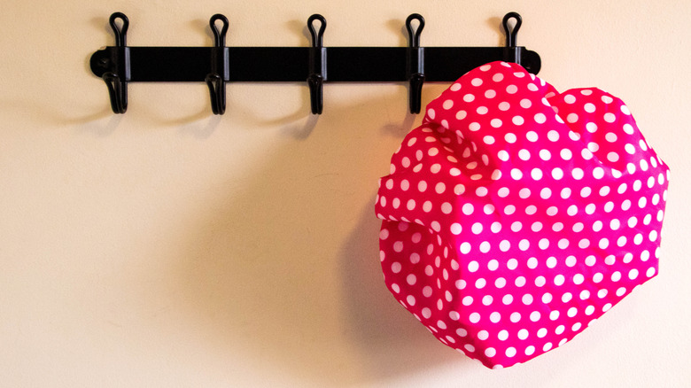 Pink shower cap on a hanger
