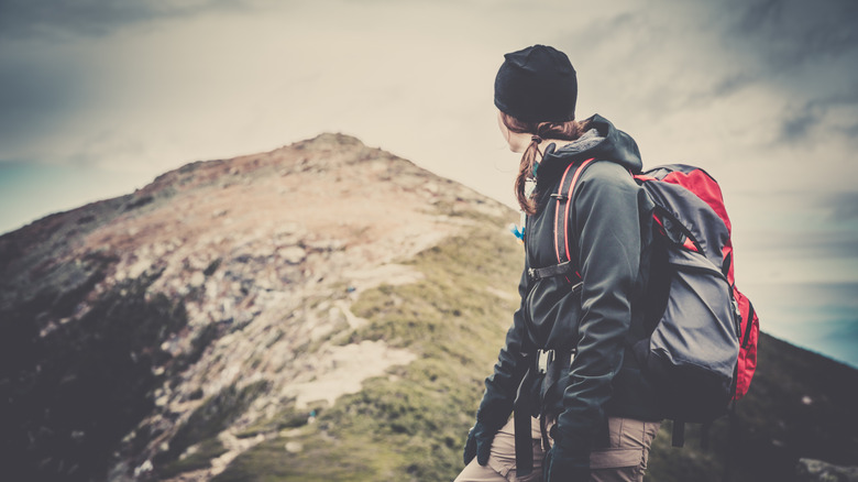 Female backpacker staring at a summit on the Pemi Loop