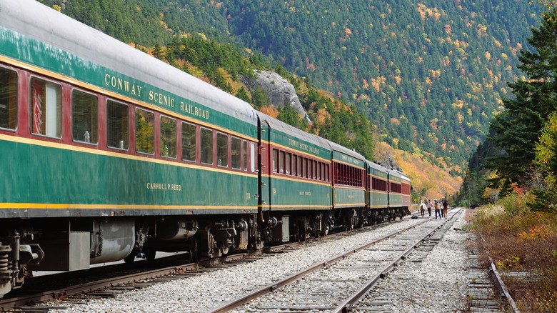 Passenger cars for the Conway Scenic Railroad idle on tracks