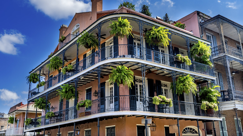 orange building with ferns, wrought iron siding