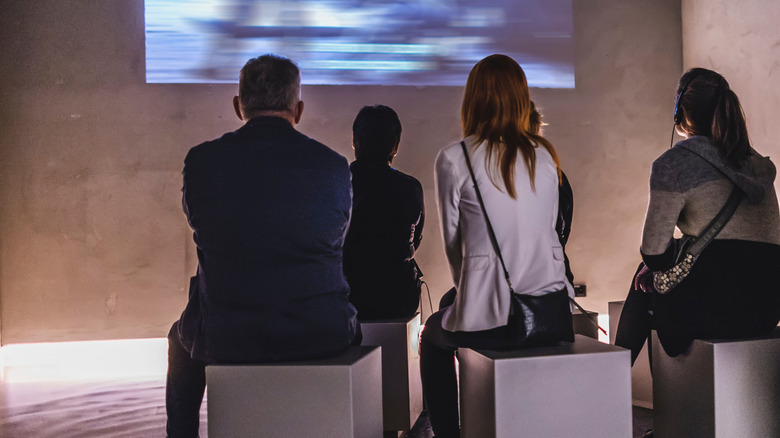 People watching video art.