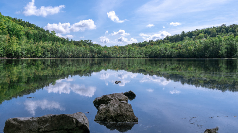 Glassy Glacier Lake surrounded by forest in Clark Reservation State Park