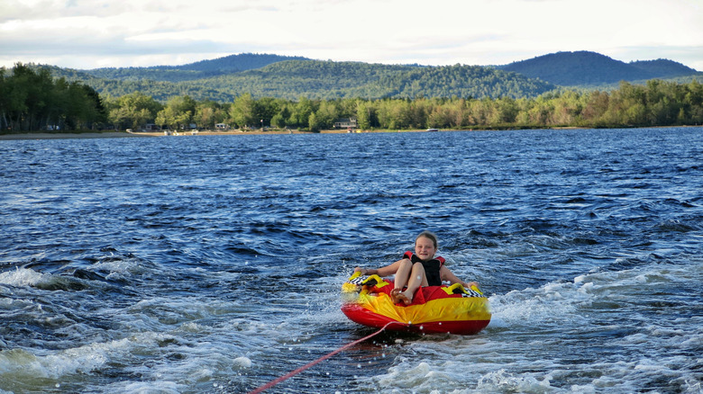 A girl goes tubing on the lake