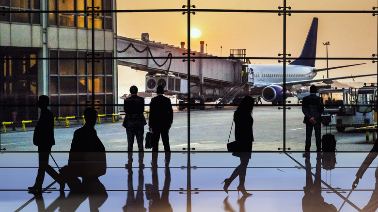 Busy airport terminal at sunrise