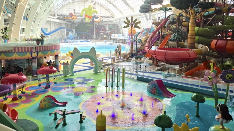 Colorful water park features and pools in the giant indoor arena of DreamWorks water park.