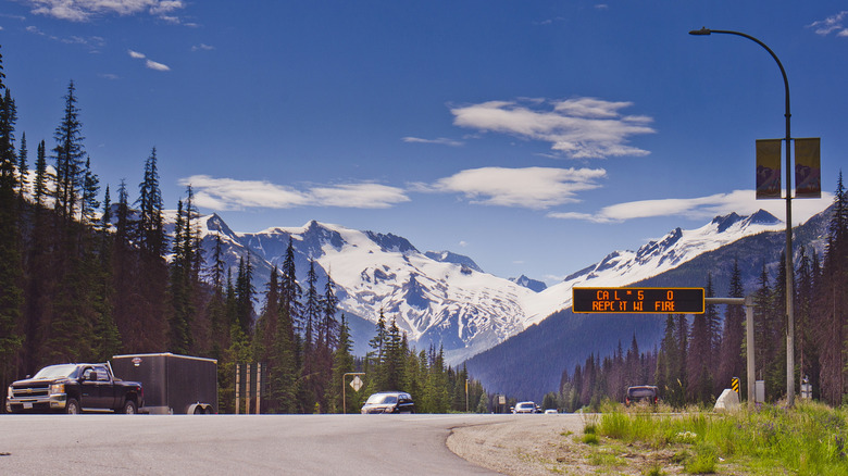 Highway passing through the snow-capped mountains near Rogers Pass in Glacier National Park.