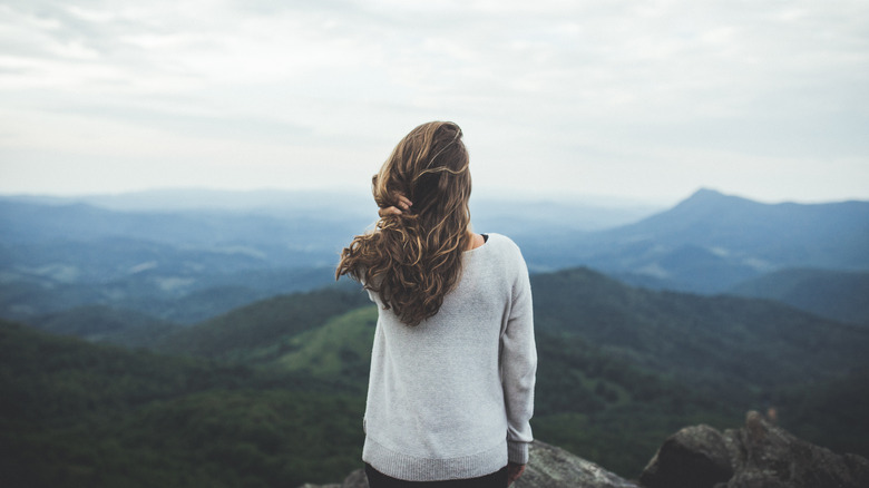 Woman hiker looking out over the mountains