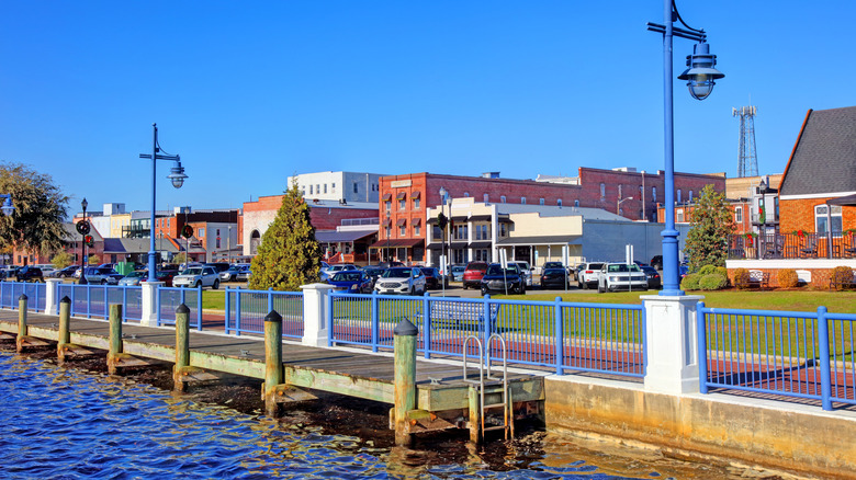 Riverside boardwalk with docks in a historic downtown