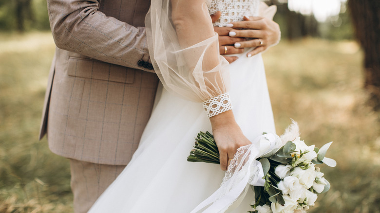 Close up bride and groom bouquet outdoor wedding