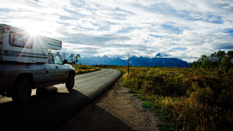 An RV drives through Yellowstone National Park.