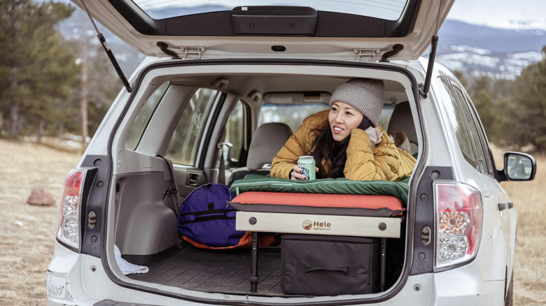 Camper laying on a Hele box car camping platform