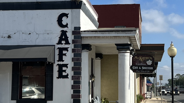 a picture of Miz Kathi's restaurant, with white facade and Cafe painted on the side.