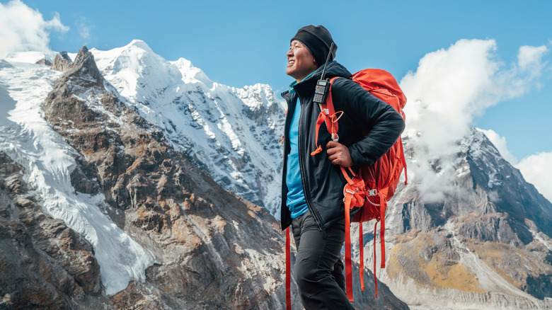 A Nepali guide looks on as the Himalayas rise all around
