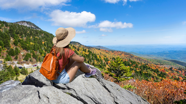 a hiker gazes over the mountains at Banner Elk in North Carolina