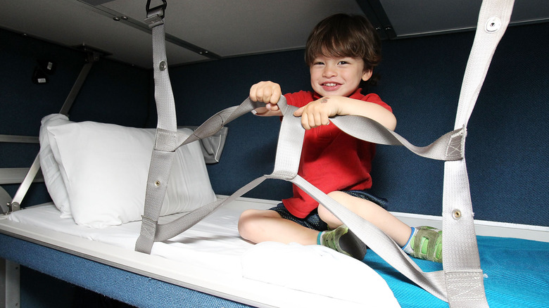 A child on an Amtrak bunk bed.
