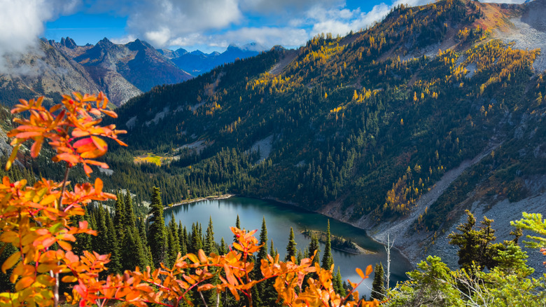 High alpine lake in North Cascades National Park framed by red, yellow, and green trees in the autumn