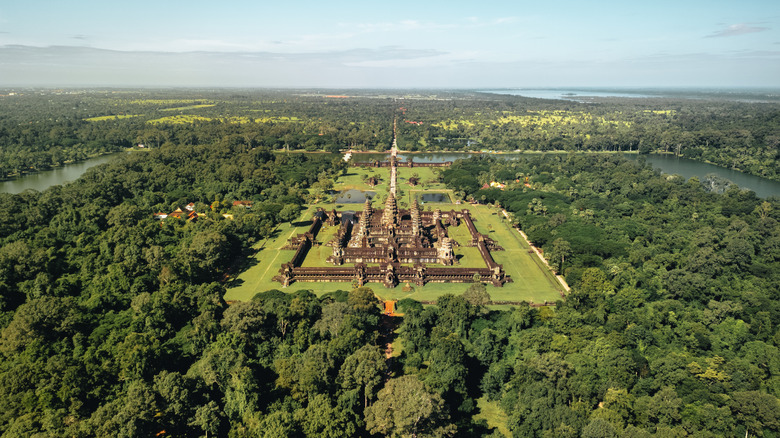 drone shot of Angkor Wat in Cambodia showing the full layout of the temple complex surrounded by tropical forest