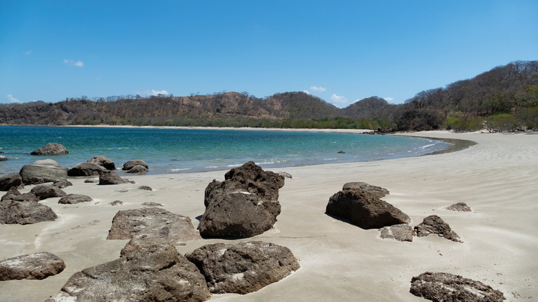 Empty beach surrounded by mountains