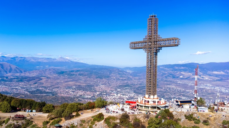 large cross on hilltop overlooking city