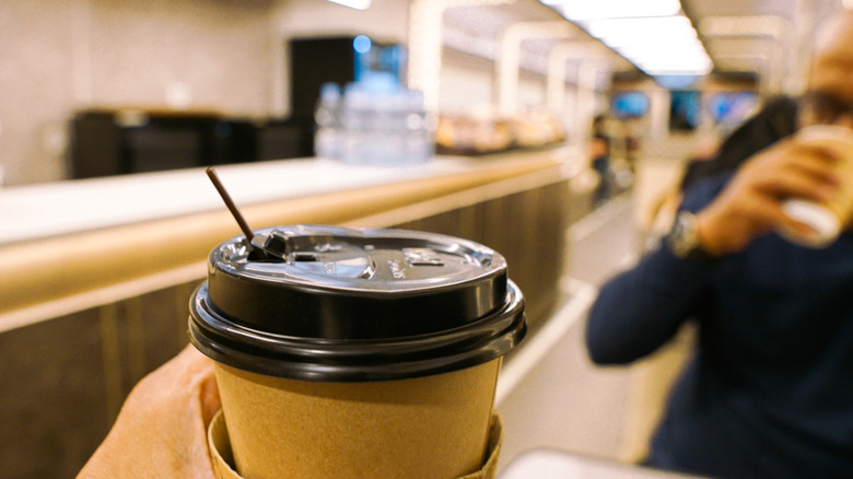 Cup of coffee in a train dining car with a blurred background
