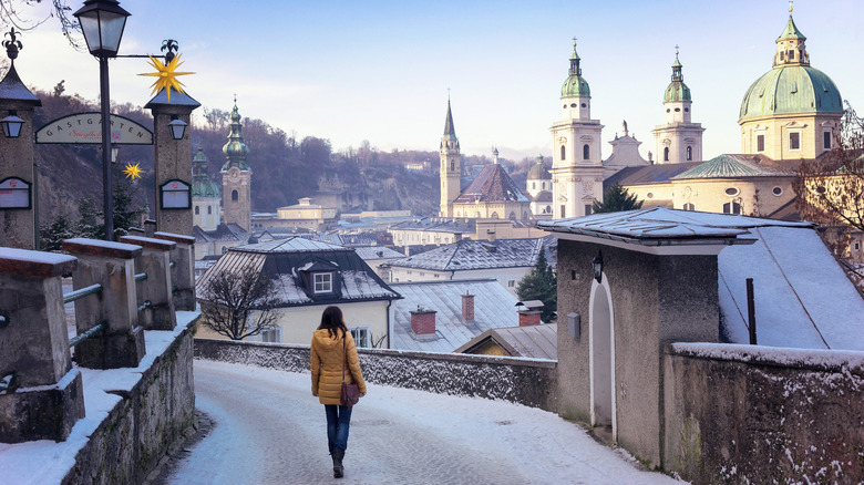 Person walking in snowy Salzburg