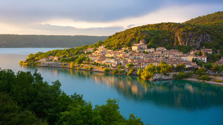 Hillside village with tiled rooftops on the shores of a blue lake
