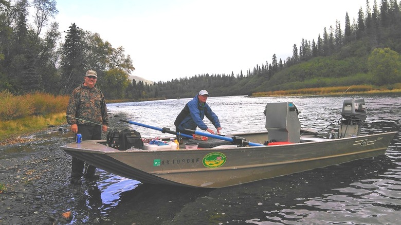 people readying their boat for a trip on a forested waterway in Wood-Tikchik State Park