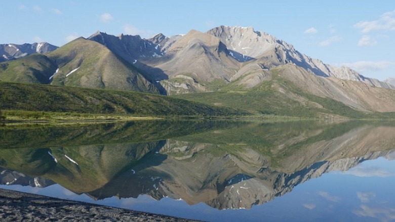 Mountains reflected in a lake at Nááts'įhch'oh National Park Reserve