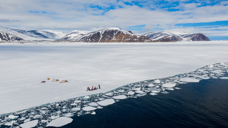 A view of tourists on the ice floe at Sirmilik National Park in Canada.
