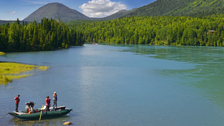 raft on the Kenai River surrounded by forest and mountains