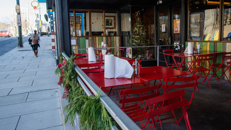 Red dining chairs and tables at an open air restaurant in Asheville, North Carolina.